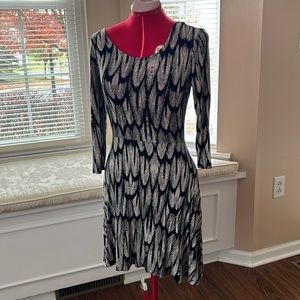 Black and cream feather print dress with 3/4” length sleeves.